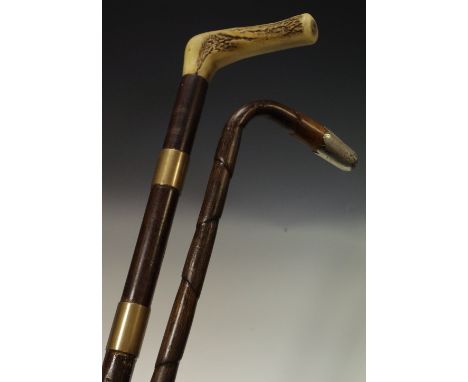 An early 20th century silver topped walking stick; a horn handled walking stick