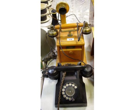 A retro dial bakelite telephone; a reproduction candlestick telephone; another