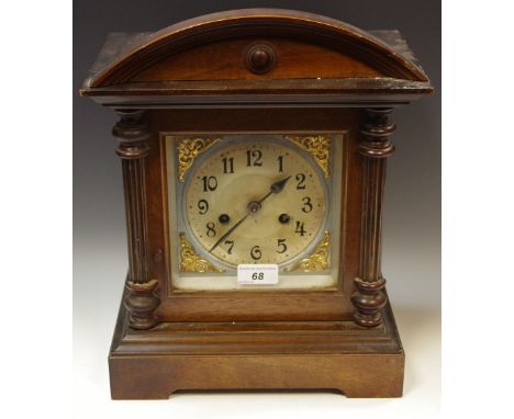 An early 20th century mahogany arch top architectural mantel clock, eight day movement, Arabic numerals on silvered dial, 36.