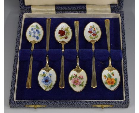 A set of six Elizabeth II silver-gilt and enamel coffee spoons, each engine turned and decorated in polychrome with flowers, 