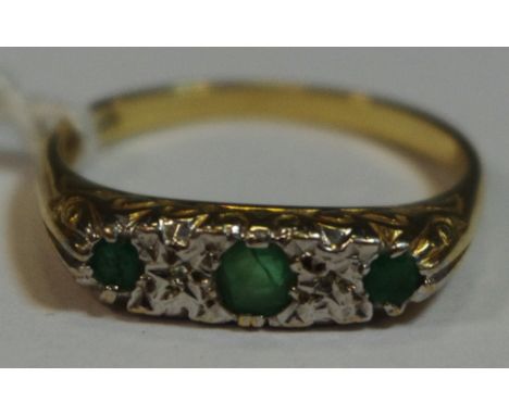 A 9ct gold ring set with three emeralds and two diamond chips, size O, 2.2g (1)