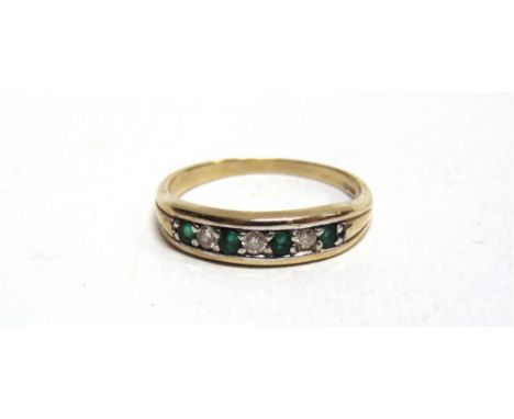 A 9 CARAT GOLD EMERALD AND DIAMOND HALF HOOP RING the three brilliant cuts totalling approximately 0.12 carats, finger size r