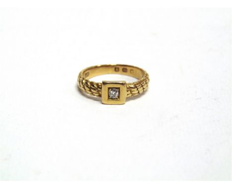 AN 18 CARAT GOLD RING the cord mount set with an old cut diamond of approximately 0.08 carats, finger size L, 4g gross