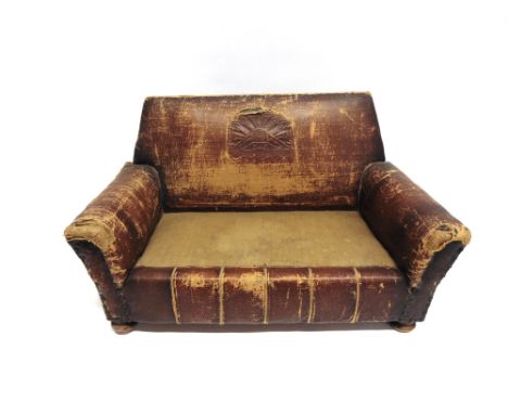 A MINIATURE SOFA  possibly an apprentice piece or shop display item, the brown rexine cover with an embossed motif to the bac