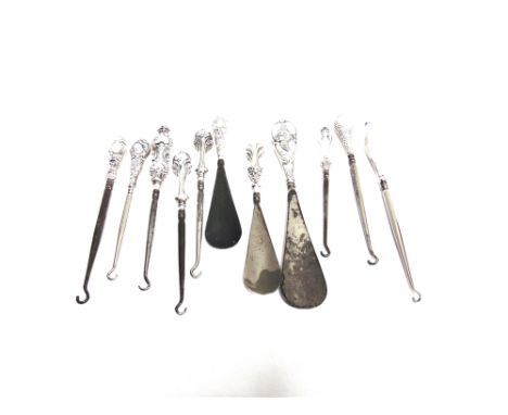 A COLLECTION OF EIGHT SILVER HANDLED BUTTON HOOKS with three silver handled shoe horns 