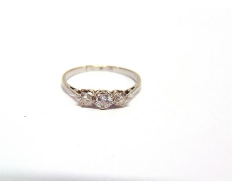 A THREE STONE DIAMOND RING stamped 'Plat', the graduated brilliant cuts totalling approximately 0.44 carats, shank split, 2.1