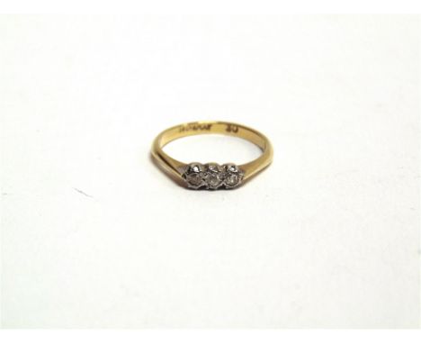 A THREE STONE DIAMOND RING stamped '18ct Plat', illusion set, finger size L, 2g gross