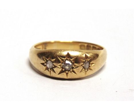 AN 18 CARAT GOLD THREE STONE DIAMOND RING Birmingham 19??, star set with two rose cuts and an old single cut, finger size P, 