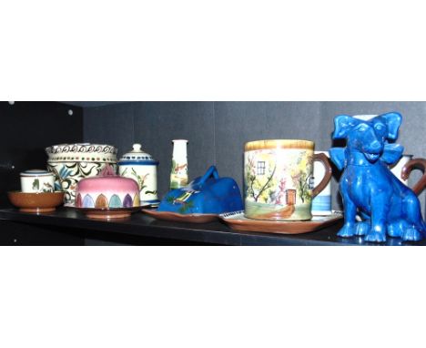 A COLLECTION OF ASSORTED DEVONWARE including a blue seated dog 18cm high wearing a bow around his collar, ceramic tray, butte