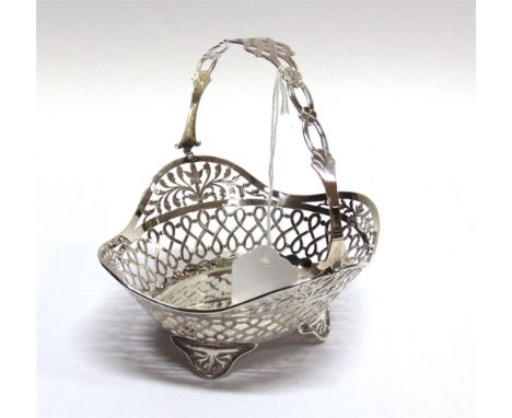 A SILVER PIERCED BON BON BASKET By Goldsmiths Co Ltd, London 1910, with a swing handle, on pierced bracket supports, 15cm lon