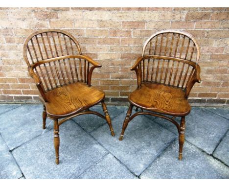 A PAIR OF BOW-BACK WINDSOR ARMCHAIRS  with turned supports on crinoline stretcher bases, the dished seats 48cm wide 47cm, dee