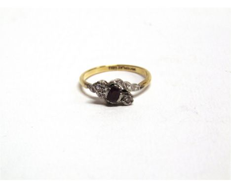 A RUBY AND ILLUSION SET DIAMOND THREE STONE CROSS OVER RING stamped '18ct Plat', finger size P, 2.8g gross