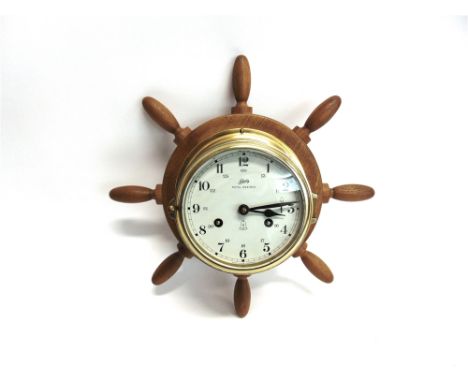 A 'SCHATZ ROYAL MARINER' BRASS CASED SHIPS BULKHEAD TYPE CLOCK on an oak ships wheel mount, 36cm total diameter