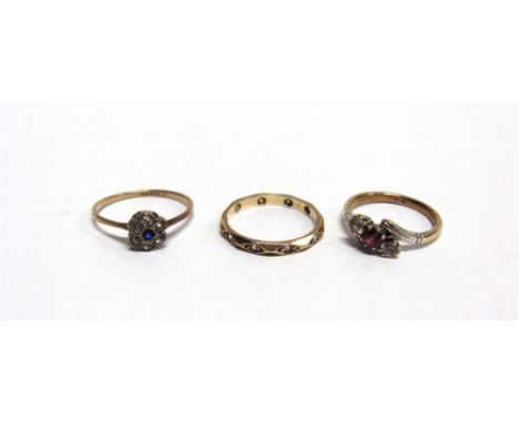 A THREE STONE RING a synthetic stone cluster ring; and an eternity ring; all stamped '9ct'; 5.2g gross