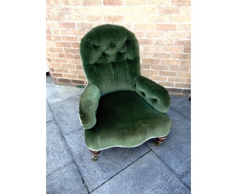 A VICTORIAN ARMCHAIR  with green velvet button upholstery, serpentine front seat on turned front supports, 69cm wide 80cm dee