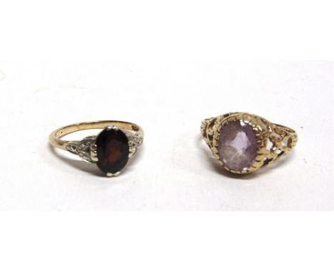 A GARNET RING stamped '9ct'; with a 9 carat gold pale amethyst ring; 5.5g gross