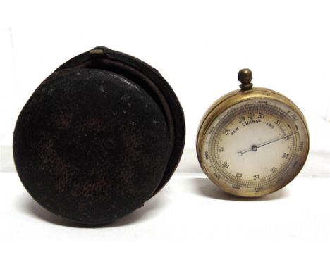 A POCKET BAROMETER  with a circular silvered dial and a gilt metal body, in a leather travel case.