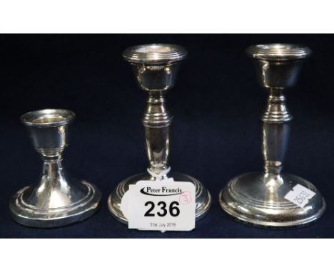 Pair of silver dwarf candlesticks, Birmingham hallmarks, together with another dwarf candlestick. (3)(B.P. 24% incl. VAT)