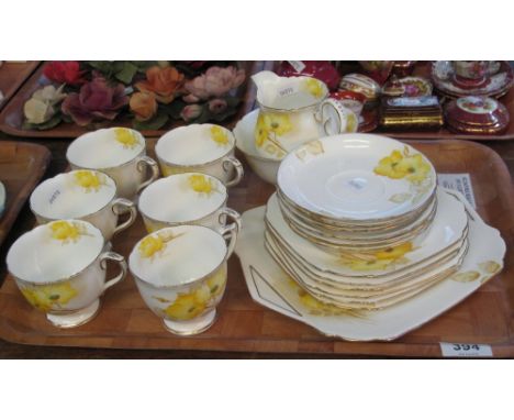 21 piece Shelley fine bone china tea service on a white ground with yellow flowers amongst foliage.(B.P. 24% incl. VAT) CONDI