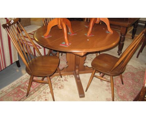 Elm Ercol extending dining table, together with a set of four Ercol spindle chairs with gold labels. (5)(B.P. 24% incl. VAT)