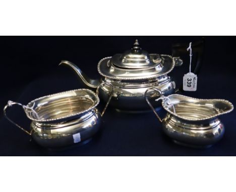 Three piece silver tea service to include; teapot, cream jug and two handled sucrier with ebonised handle and finial, Sheffie