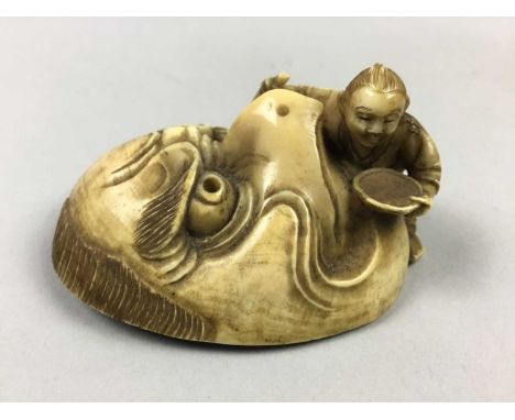 JAPANESE IVORY NETSUKE,Meiji period, modelled as a Noh mask with child, signed, 6.4cm high