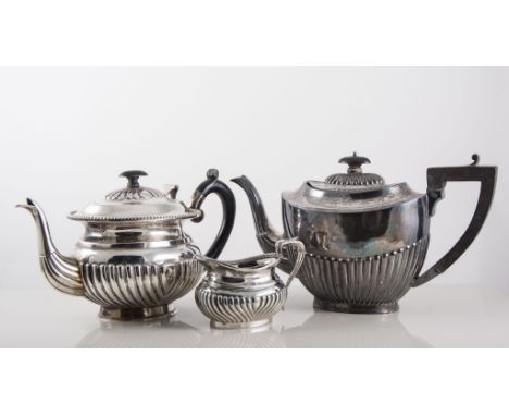 Three piece plated tea service, with beaded outlines, a similar tea pot in the Regency manner with creamer, another plated te