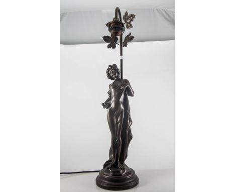 Art Deco style bronzed figural lamp of a girl holding flowers, lacking shade, 69cm.