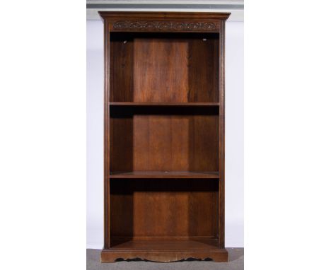 Old Charm oak open bookcase, moulded cornice, carved frieze, fixed and adjustable shelves, on bracket feet, width 99cms.
