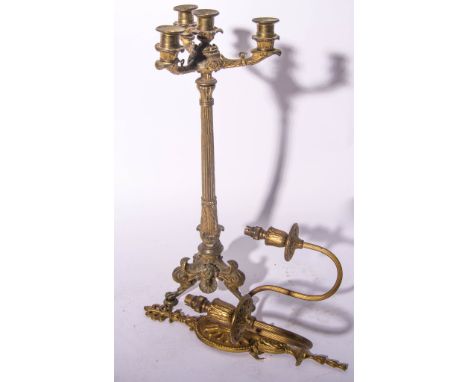 Gilt metal three-light candelabra, paw feet, height 51cms and a set of four Neoclassical brass wall lights, (5).