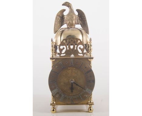 Modern lantern clock, eagle finial, circular chapter ring, musical movement, height 27cm.