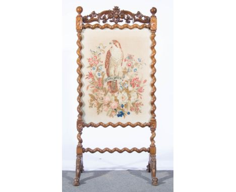 Victorian walnut firescreen, scrolled surround, woolwork panel of a bird and flowers, height 140cm.