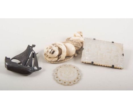 Japanese ivory netsuke man resting on a leaf, 55mm, signed on base, a silver galleon brooch 35mm, hallmarked Chester 1936, an