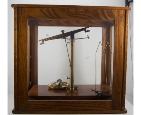 Set of pharmaceutical beam balance scales, A. Gallenkamp & Co., London, oak case, width 45cms.