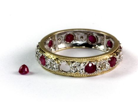 A 9ct yellow and white gold ruby and diamond full eternity ring (one ruby is out of the setting but it is kept with the ring)