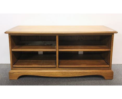 An Ercol oak cabinet with pull out lower shelves, W. 111 x 52 x 50cm.