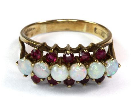 A 9ct yellow gold ruby and opal set ring (T).