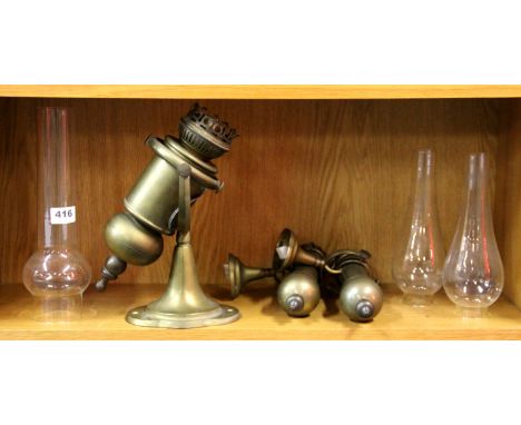 One large and a pair of smaller brass gimble oil lamp style electric wall lights.