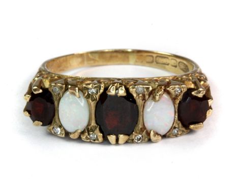 A 9ct yellow gold opal and garnet set ring.