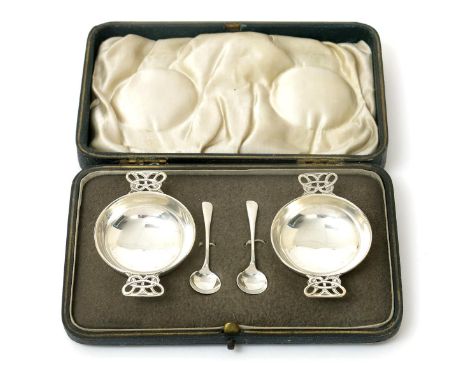 A pair of James Fenton silver salts and serving spoons,  circular with pierced Celtic knot handles, in fitted presentation bo