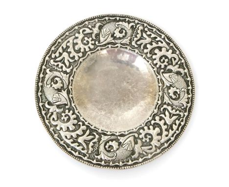 A John Pearson rare repousse silver plate, dated 1894, hammered in relief to the rim with a band of scaly Classical dolphin f