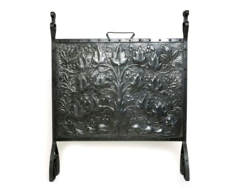A polished steel firescreen the designed attributed to John Williams, the rectangular panel hammered in low relief with a sty