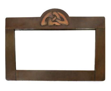 A large Liberty & Co patinated copper wall mirror designed by Archibald Knox, shaped rectangular form, stamped in relief with