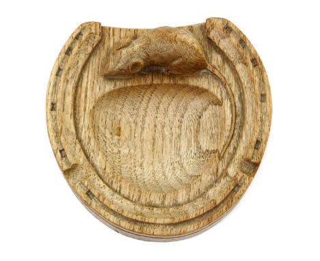 A Robert Mouseman Thompson oak ashtray,  modelled as a horseshoe, with carved mouse signature, 12.5cm.  wide