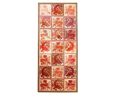 A Maw & Co tile panel designed by Lewis F Day, each tile decorated with a grotesque animal repeat, glazed ruby lustre on a cr