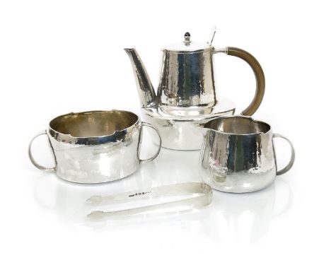 A Liberty & Co silver four piece tea service designed by Archibald Knox, model no. 5237,  comprising tea pot and hinged cover