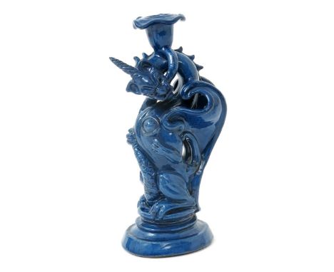 A C.H. Brannum Barum grotesque dragon candlestick, modelled rearing up, glazed blue, impressed marks, restored, 29.5cm. high 
