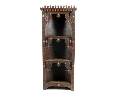 An Anglo-Moorish corner cabinet probably retailed by Liberty & Co, with carved decoration set with mashrabiya  and mother of 