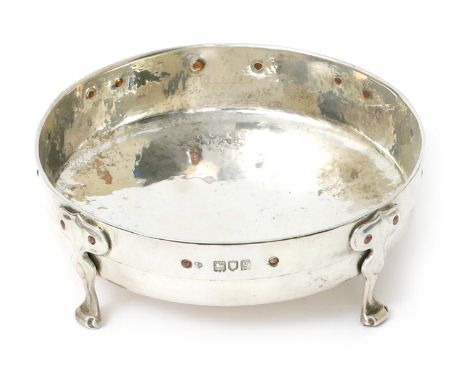 A William Hutton & Sons silver bowl designed by Kate Harris, the shallow hammered bowl on for strap work feet, set with simpl