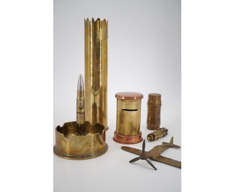 A Second World War "trench art" table cigarette lighter fabricated from a 1942 US shell case, a trench art vase, model aircra